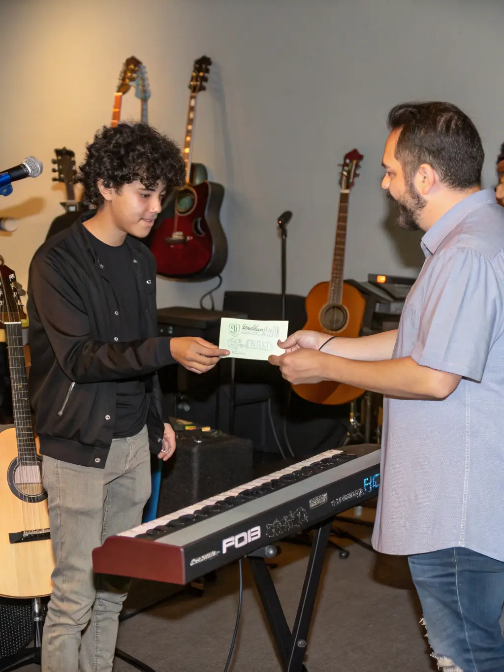 A close-up shot of an artist receiving financial assistance or a grant check, highlighting NO FUEL's commitment to supporting artists' financial needs.